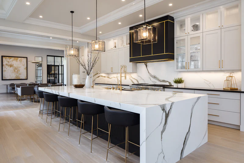 Black and white kitchen with Calacatta quartz and velvet seating
