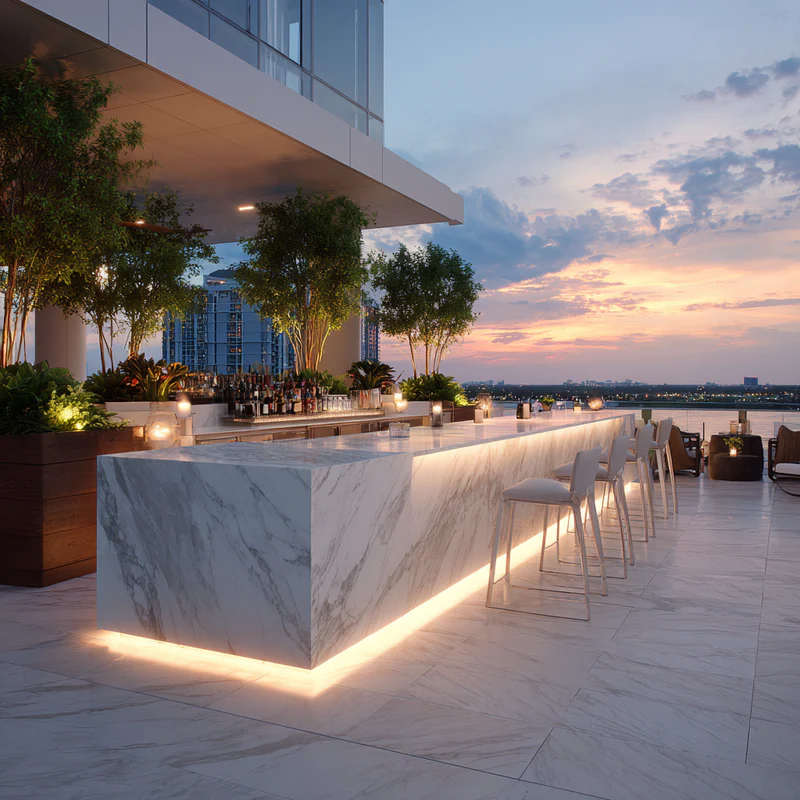 Luxury waterfront marble bar with illuminated countertops at sunset in South Florida